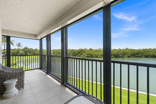 sunroom with a water view and a wealth of natural light