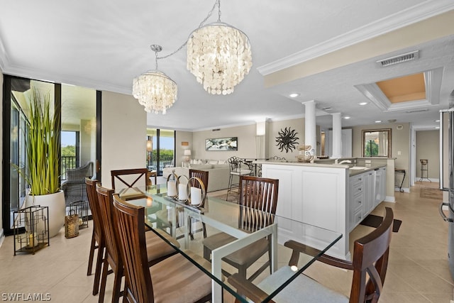 tiled dining room with ornate columns, crown molding, and a chandelier