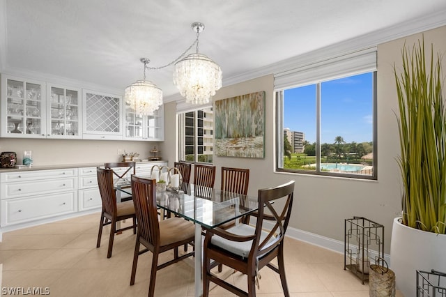 tiled dining space with a chandelier and crown molding