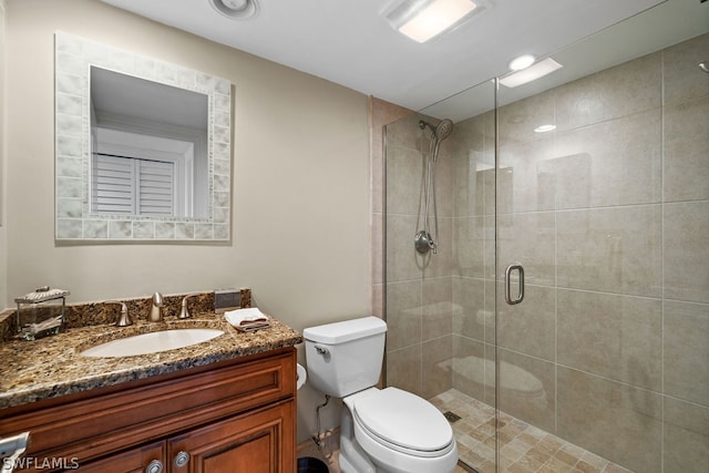 bathroom with vanity, an enclosed shower, and toilet