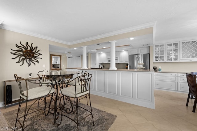 dining room with light tile patterned floors and ornamental molding