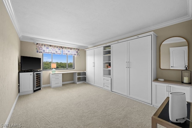 interior space with light carpet, beverage cooler, and crown molding