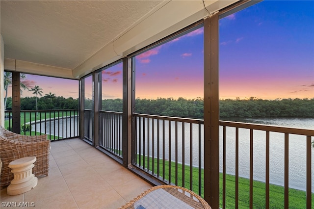 sunroom / solarium with a water view