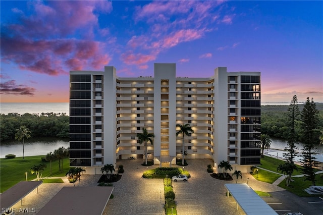 outdoor building at dusk featuring a water view