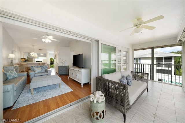 tiled living room featuring ceiling fan