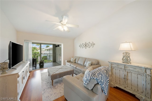 living room featuring ceiling fan, hardwood / wood-style floors, and lofted ceiling