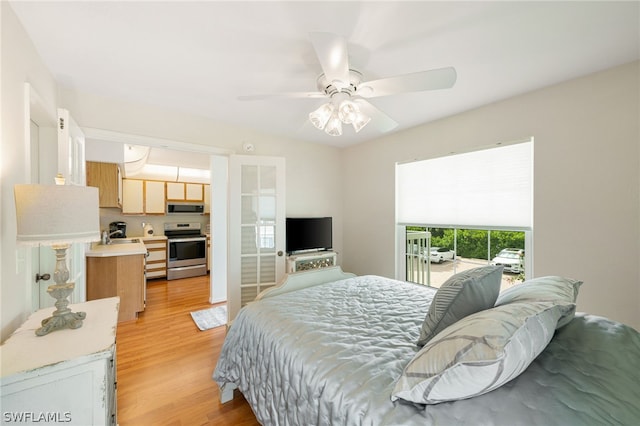 bedroom with ceiling fan, light hardwood / wood-style floors, and access to exterior