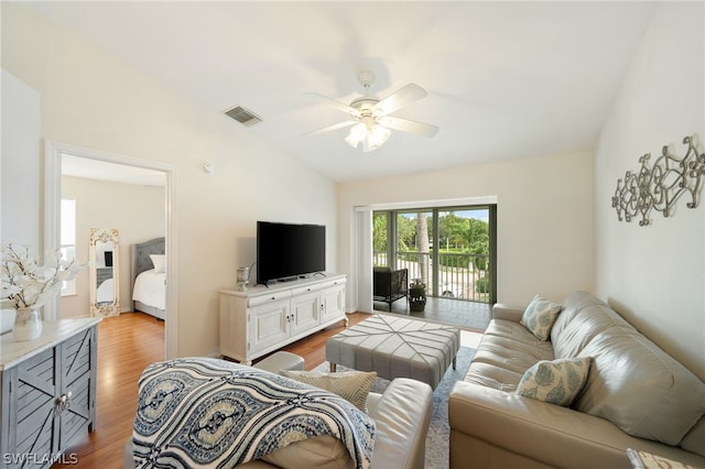 living room with lofted ceiling, wood-type flooring, and ceiling fan