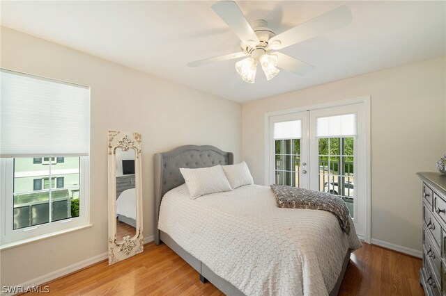 bedroom featuring access to outside, light hardwood / wood-style floors, french doors, and ceiling fan