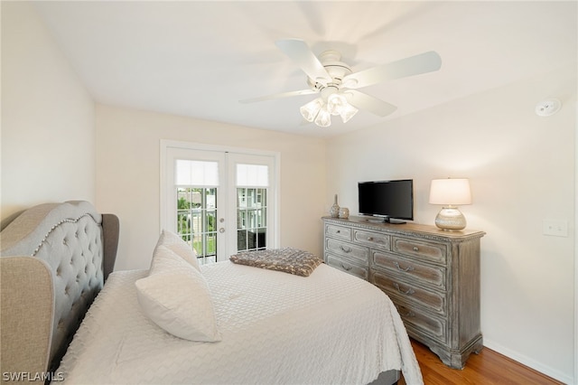 bedroom featuring ceiling fan, access to exterior, french doors, and wood-type flooring