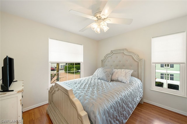 bedroom with ceiling fan and hardwood / wood-style flooring