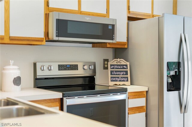 kitchen with white cabinetry and stainless steel appliances