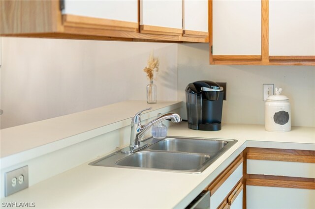 kitchen featuring white cabinetry and sink