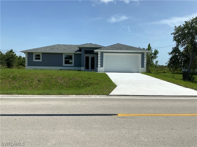 view of front of house with french doors, a front lawn, and a garage