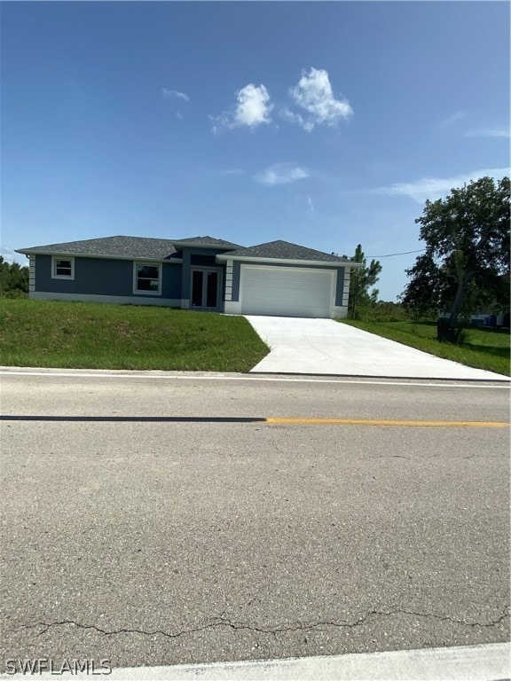 view of front facade with a garage and a front lawn