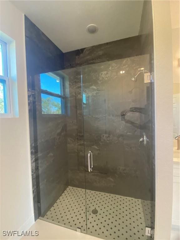 bathroom featuring a shower with shower door