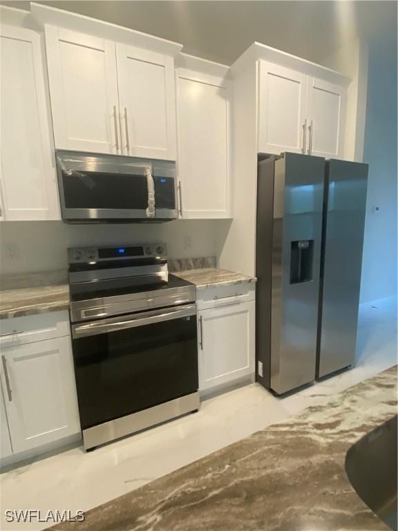 kitchen with white cabinets and appliances with stainless steel finishes