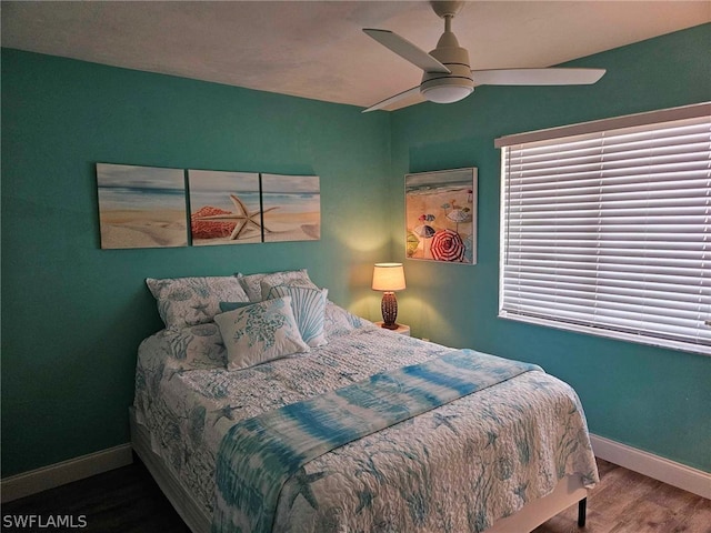 bedroom with ceiling fan and hardwood / wood-style flooring