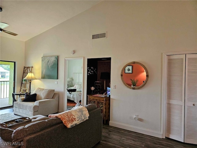 living room with lofted ceiling, ceiling fan, and dark hardwood / wood-style floors