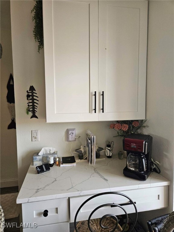 kitchen with white cabinets and light stone counters