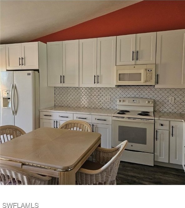 kitchen featuring white cabinets, decorative backsplash, white appliances, and vaulted ceiling