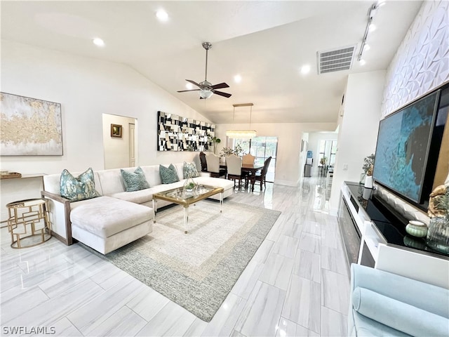 tiled living room with vaulted ceiling, ceiling fan, and rail lighting