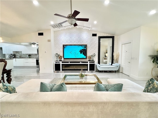 living room featuring ceiling fan, vaulted ceiling, and light hardwood / wood-style flooring