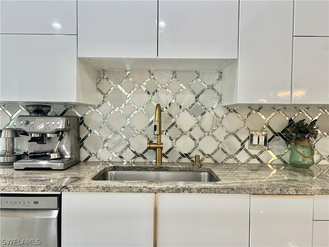 kitchen featuring sink, white cabinets, backsplash, and stainless steel dishwasher