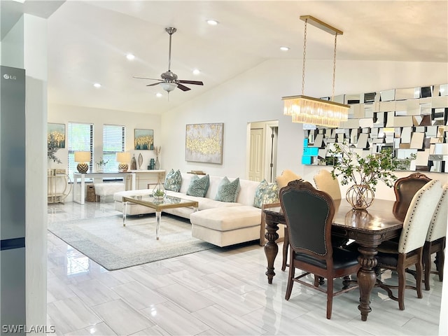 dining room with high vaulted ceiling, ceiling fan with notable chandelier, and light tile flooring