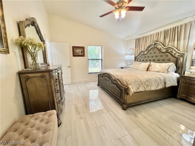 bedroom with ceiling fan, vaulted ceiling, and light hardwood / wood-style flooring