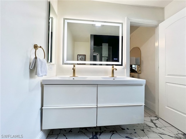 bathroom with tile flooring, vanity with extensive cabinet space, and double sink