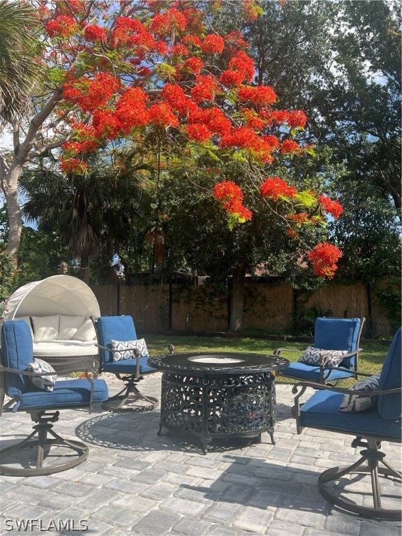 view of terrace with an outdoor fire pit