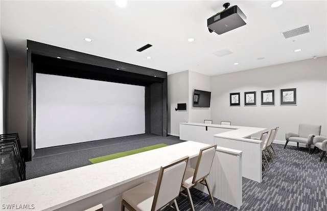 cinema room with recessed lighting, visible vents, golf simulator, and dark colored carpet