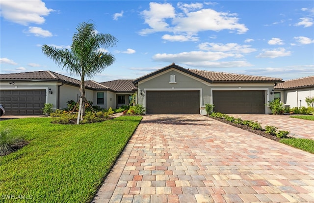 view of front of home featuring a garage and a front lawn