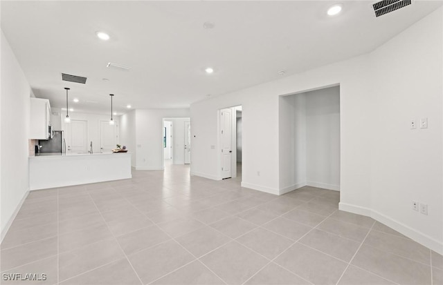 unfurnished living room with recessed lighting, visible vents, baseboards, and light tile patterned flooring