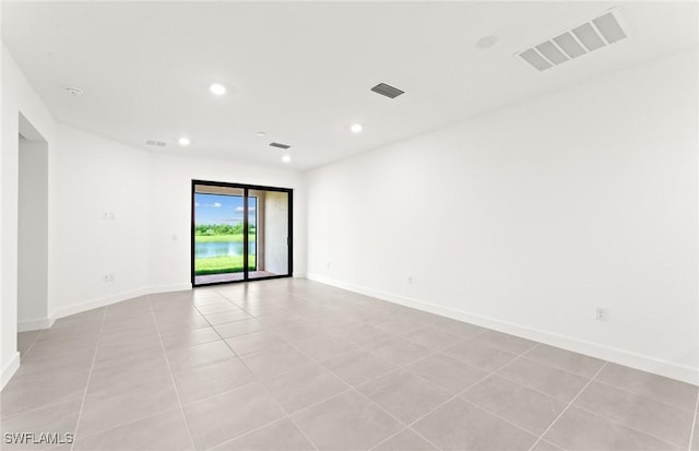 empty room with visible vents, recessed lighting, and baseboards