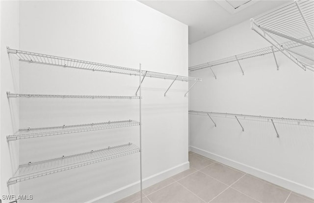 walk in closet featuring light tile patterned floors