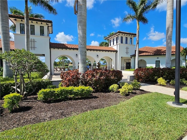 mediterranean / spanish home featuring a front yard