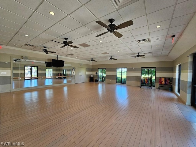 interior space with a drop ceiling and light hardwood / wood-style floors