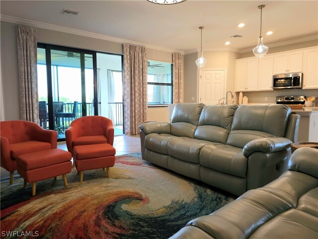 living room with light tile patterned floors and crown molding