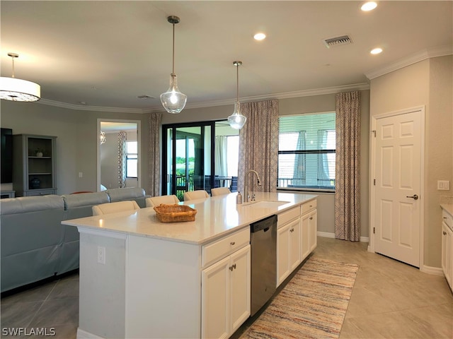 kitchen featuring a kitchen island with sink, white cabinets, stainless steel dishwasher, and decorative light fixtures