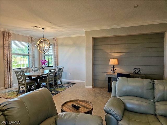 tiled living room featuring a notable chandelier, ornamental molding, and a textured ceiling