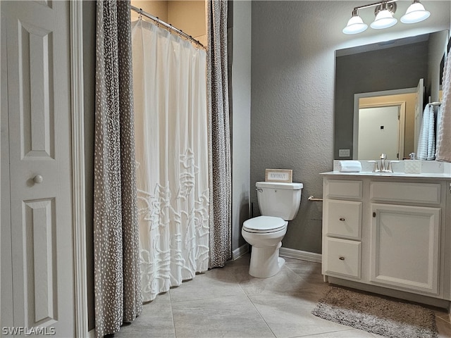 bathroom featuring curtained shower, tile patterned flooring, vanity, and toilet