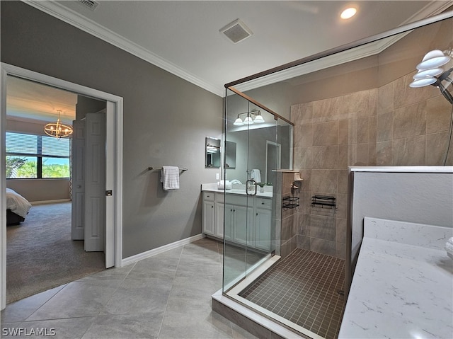 bathroom with vanity, crown molding, tiled shower, an inviting chandelier, and tile patterned flooring