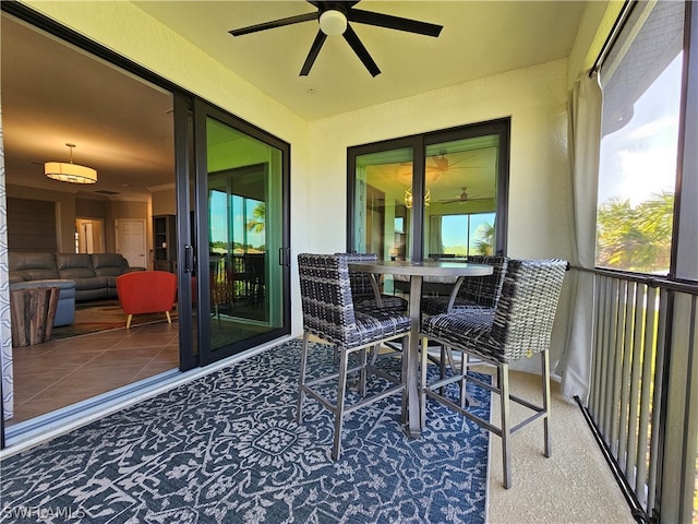 sunroom featuring ceiling fan