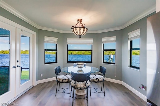 dining space with french doors, hardwood / wood-style flooring, and a wealth of natural light