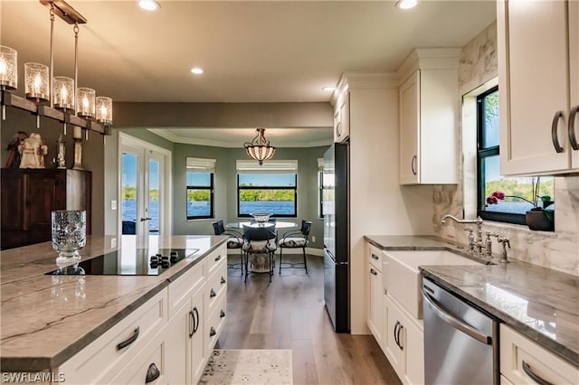 kitchen featuring white cabinetry, pendant lighting, light stone counters, and black appliances