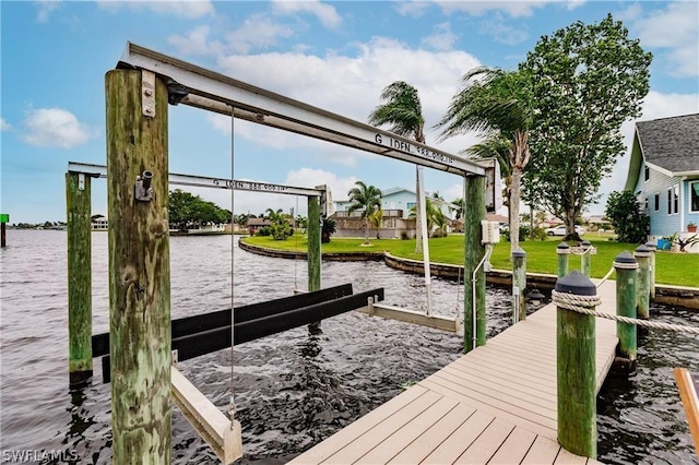 view of dock featuring a water view and a lawn