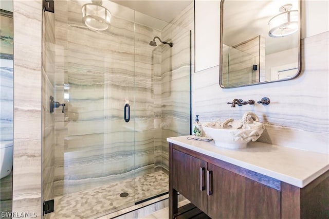 bathroom with vanity and a shower with shower door