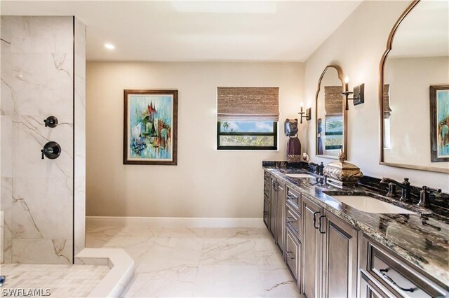 bathroom with vanity and tiled shower